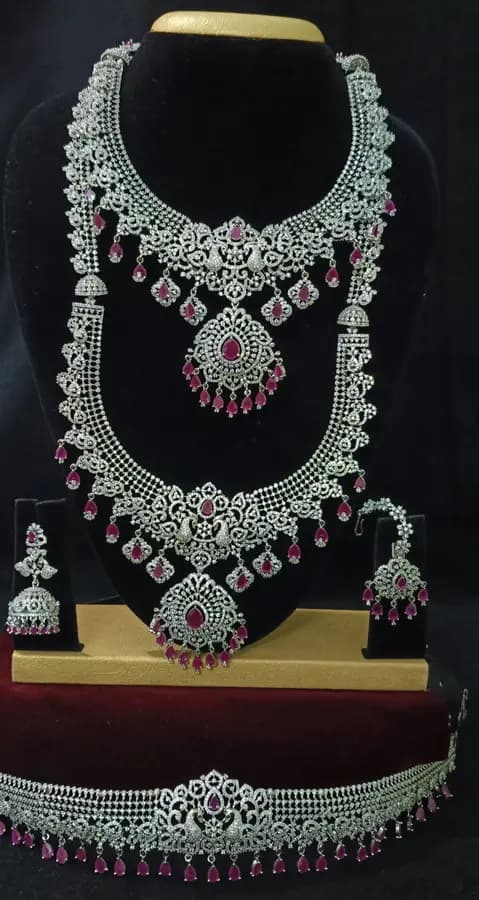 American diamond bridal jewellery set — white stone choker, haram and jhumka on a display stand