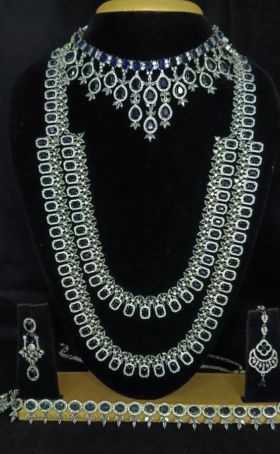 American diamond bridal jewellery set — white stone choker, haram and jhumka on a display stand