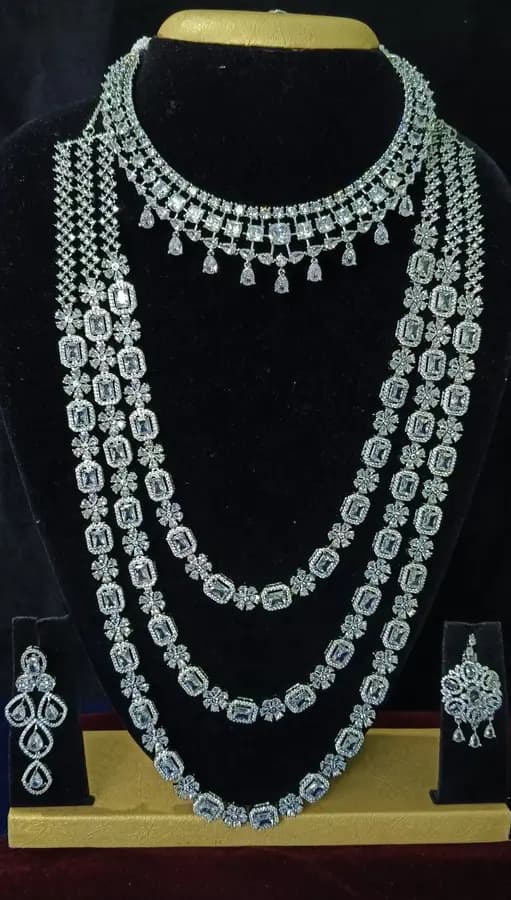 American diamond bridal jewellery set — white stone choker, haram and jhumka on a display stand