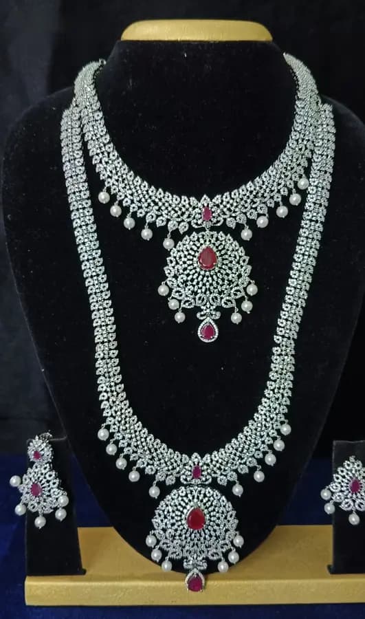 American diamond bridal jewellery set — white stone choker, haram and jhumka on a display stand