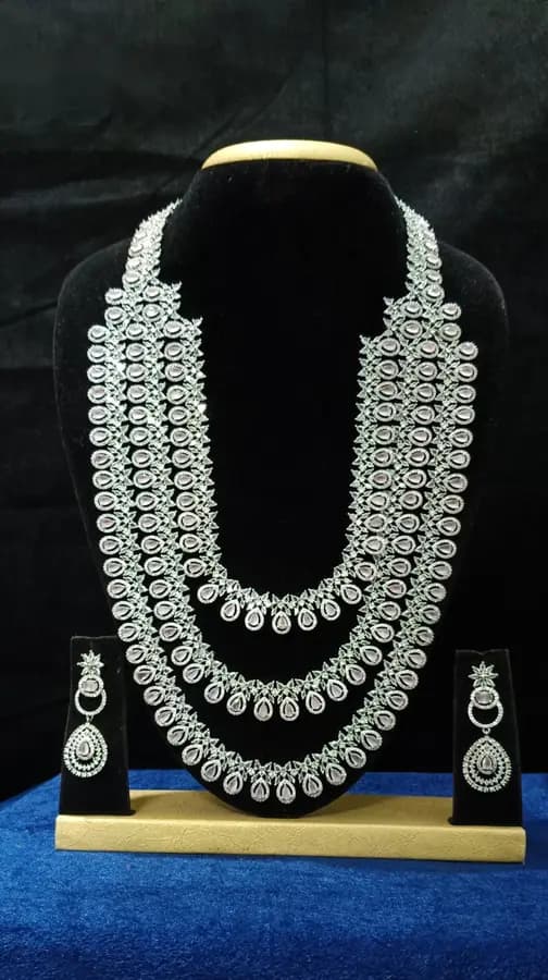 American diamond bridal jewellery set — white stone choker, haram and jhumka on a display stand