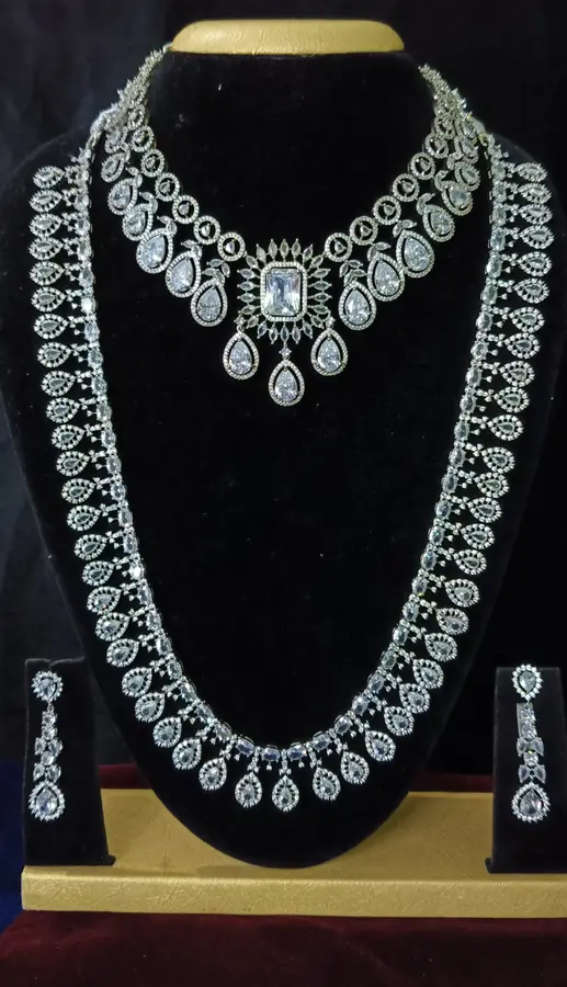American diamond bridal jewellery set — white stone choker, haram and jhumka on a display stand