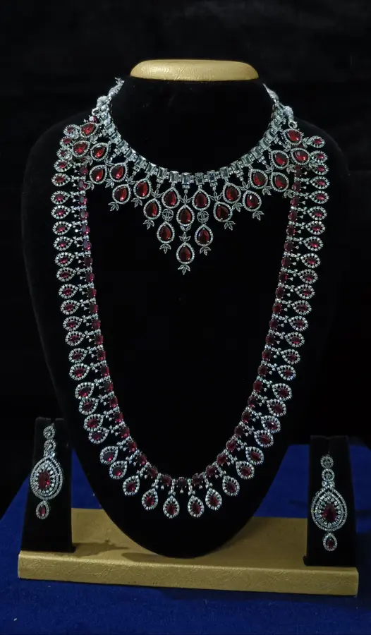 American diamond bridal jewellery set — white stone choker, haram and jhumka on a display stand