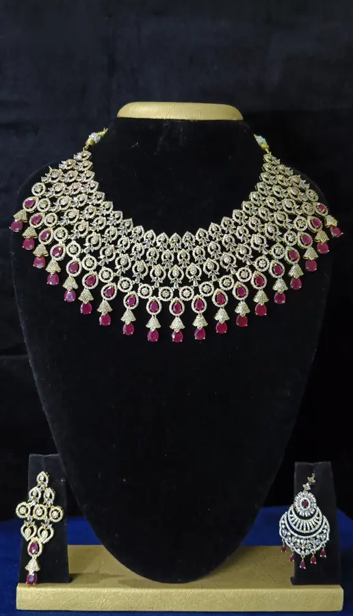 Stone-set bridal choker necklace with matching earrings on a display stand