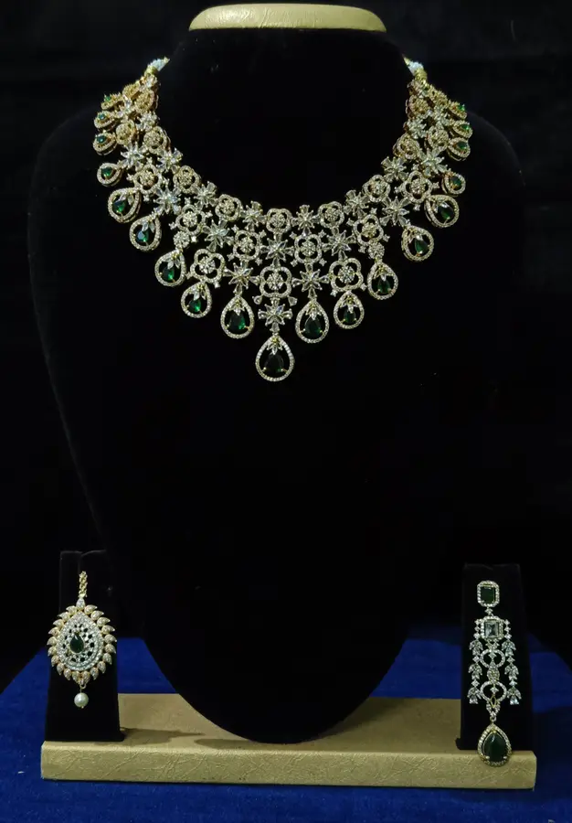 Stone-set bridal choker necklace with matching earrings on a display stand