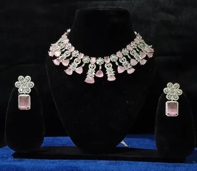 Stone-set bridal choker necklace with matching earrings on a display stand